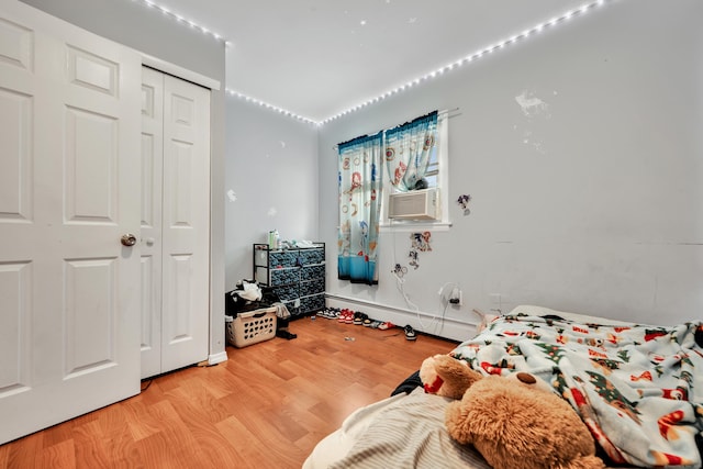 68 Round Tree Dr Unit 9, Naugatuck, CT 06770 - bedroom with light wood-type flooring, a closet, baseboard heating, and cooling unit