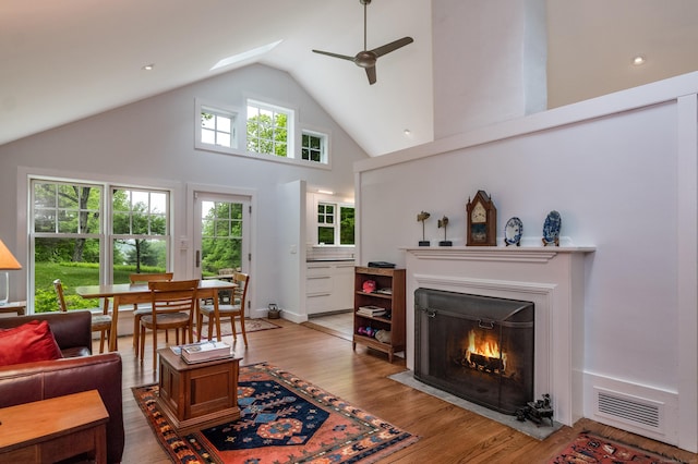 24 River Rd, Deep River, CT 06417 - living room featuring ceiling fan, high vaulted ceiling, light wood-style floors, and a fireplace with flush hearth