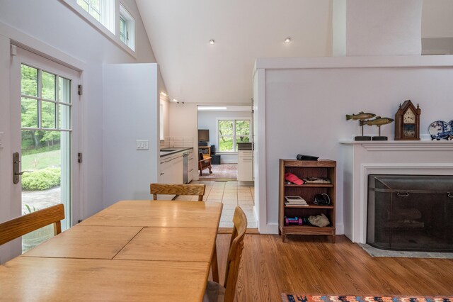 24 River Rd, Deep River, CT 06417 - dining area with a fireplace with flush hearth, light wood-type flooring, and high vaulted ceiling