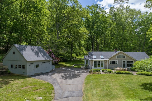 24 River Rd, Deep River, CT 06417 - view of front of home with an outdoor structure, roof with shingles, a front lawn, driveway, and a chimney