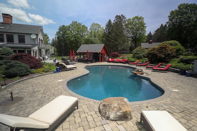289 Woodchuck Ln, Harwinton, CT 06791 - outdoor pool with a patio, an outdoor structure, and view of wooded area