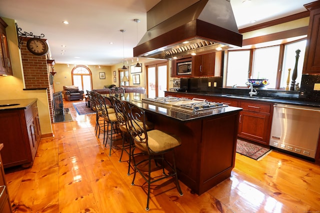 289 Woodchuck Ln, Harwinton, CT 06791 - kitchen with appliances with stainless steel finishes, exhaust hood, a kitchen bar, open floor plan, and light wood finished floors