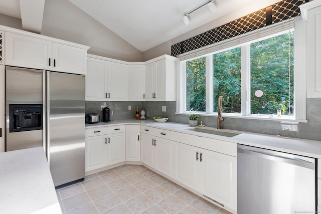 67 Old Farms Rd, Glastonbury, CT 06073 - kitchen featuring stainless steel appliances, light countertops, lofted ceiling, tasteful backsplash, and white cabinets