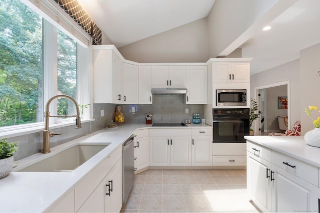 67 Old Farms Rd, Glastonbury, CT 06073 - kitchen with black appliances, tasteful backsplash, healthy amount of natural light, under cabinet range hood, and recessed lighting