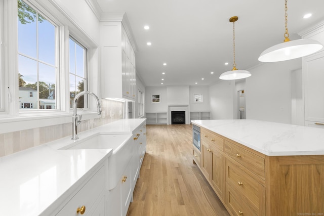 45 Robin Cir, Fairfield, CT 06824 - kitchen featuring recessed lighting, light wood-type flooring, a fireplace, a center island, and open floor plan