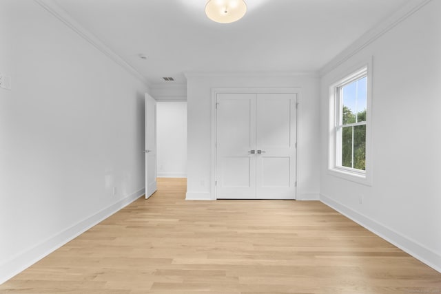 45 Robin Cir, Fairfield, CT 06824 - unfurnished bedroom with crown molding, baseboards, light wood-style flooring, and a closet