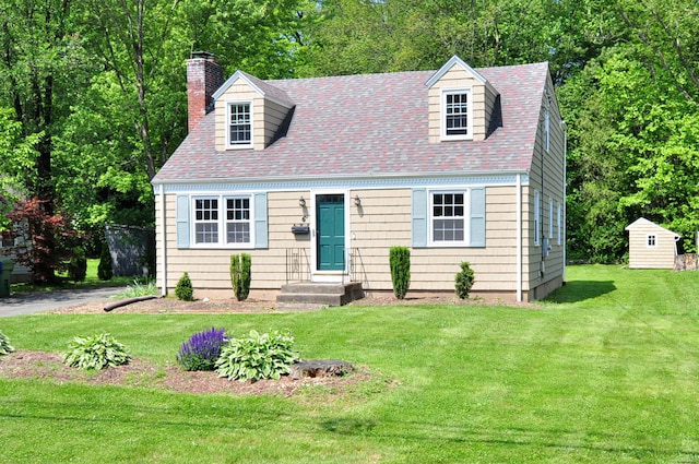 6 Lennox Ave, Windsor, CT 06095 - cape cod-style house with a chimney, a front yard, roof with shingles, and an outbuilding