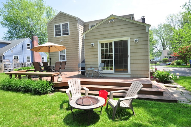 6 Lennox Ave, Windsor, CT 06095 - rear view of house with an outdoor fire pit, a chimney, a wooden deck, and a lawn