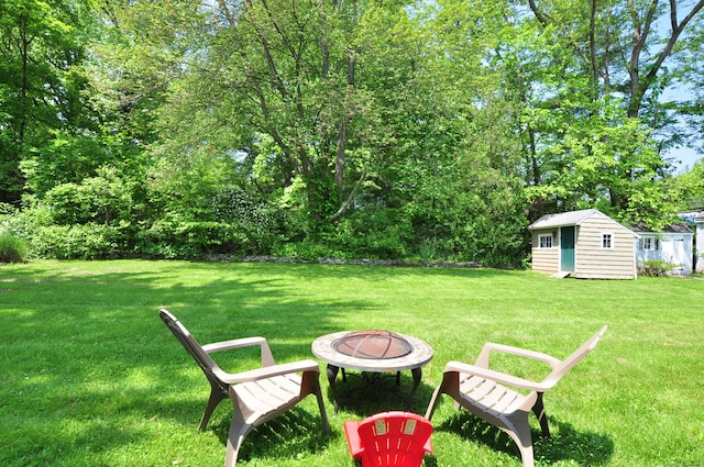 6 Lennox Ave, Windsor, CT 06095 - view of grassy yard featuring an outdoor fire pit and an outdoor structure