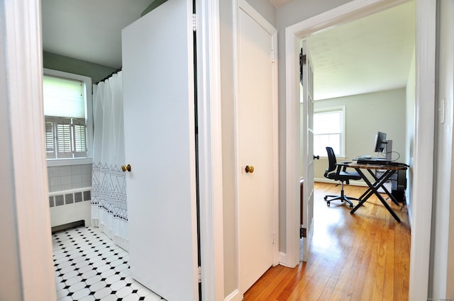 6 Lennox Ave, Windsor, CT 06095 - corridor with radiator, a desk, and light wood finished floors