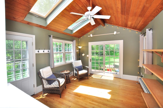 6 Lennox Ave, Windsor, CT 06095 - living area featuring a skylight, lofted ceiling, a baseboard heating unit, ceiling fan, and wood finished floors