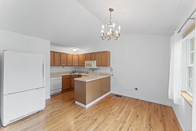 56 Pembroke Rd Apt 11, Danbury, CT 06811 - kitchen with white appliances, a sink, a peninsula, light countertops, and brown cabinetry