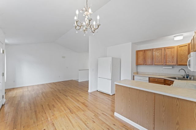56 Pembroke Rd Apt 11, Danbury, CT 06811 - kitchen with white appliances, a sink, light countertops, vaulted ceiling, and light wood-style floors
