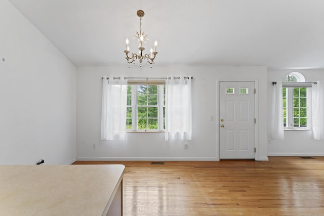 56 Pembroke Rd Apt 11, Danbury, CT 06811 - entryway featuring a chandelier, light wood finished floors, and baseboards