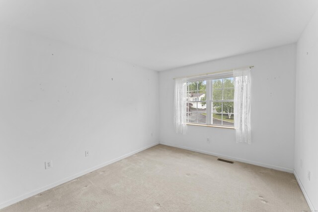 56 Pembroke Rd Apt 11, Danbury, CT 06811 - spare room featuring light carpet and baseboards