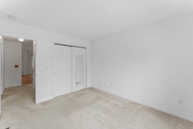 56 Pembroke Rd Apt 11, Danbury, CT 06811 - unfurnished bedroom with carpet floors, baseboards, and a closet