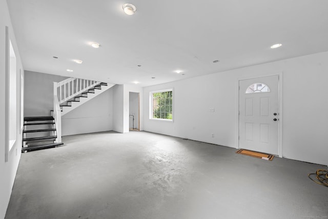 2921 Nichols Ave, Trumbull, CT 06611 - unfurnished living room featuring stairway, concrete flooring, and recessed lighting