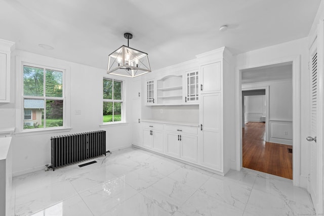 2921 Nichols Ave, Trumbull, CT 06611 - unfurnished dining area featuring radiator heating unit, a chandelier, light marble finish flooring, and baseboards