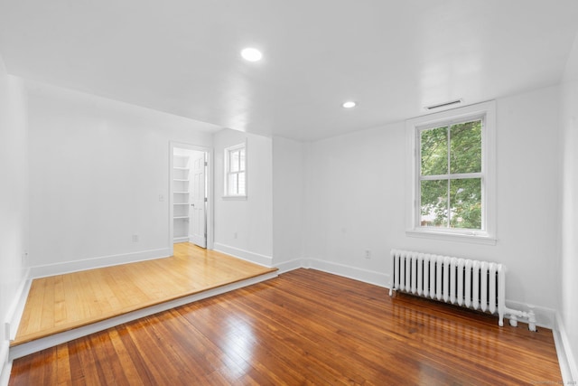 2921 Nichols Ave, Trumbull, CT 06611 - empty room featuring radiator heating unit, baseboards, healthy amount of natural light, hardwood / wood-style floors, and recessed lighting