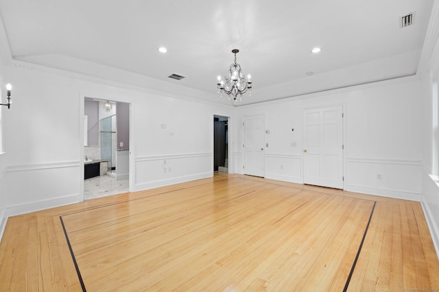2921 Nichols Ave, Trumbull, CT 06611 - unfurnished bedroom featuring a chandelier, wainscoting, crown molding, a decorative wall, and recessed lighting