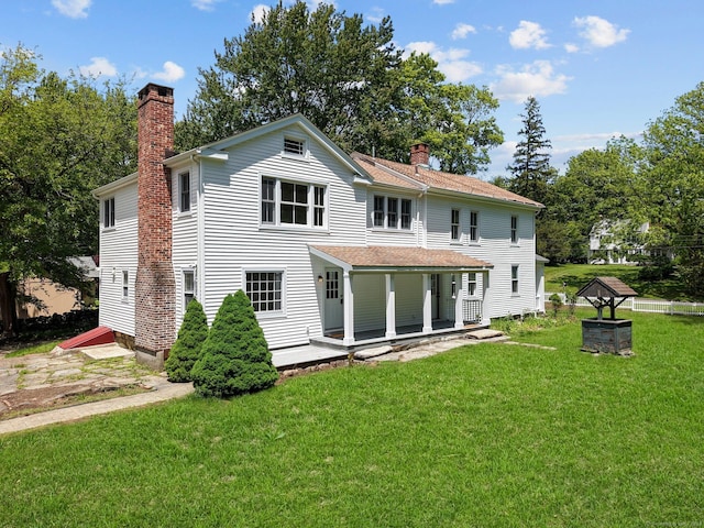2921 Nichols Ave, Trumbull, CT 06611 - rear view of house with a chimney, a lawn, covered porch, and roof with shingles