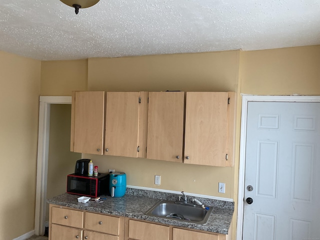 74 Branch St, Waterbury, CT 06704 - kitchen featuring a sink, light brown cabinets, and dark countertops