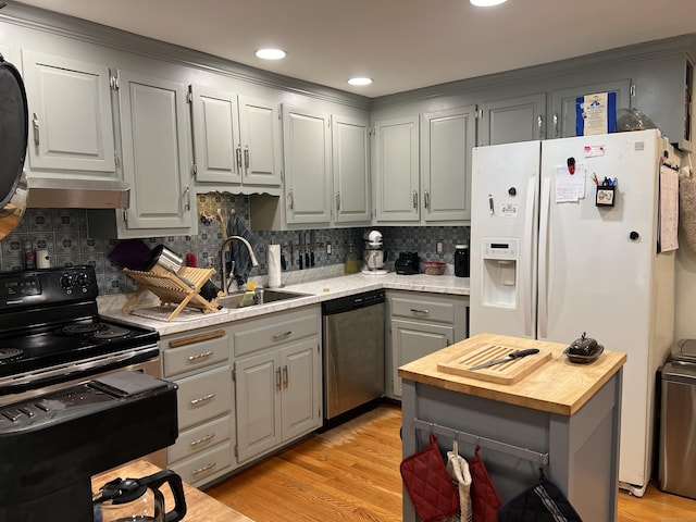 kitchen with stainless steel dishwasher, butcher block counters, gray cabinets, black range with electric cooktop, and white refrigerator with ice dispenser