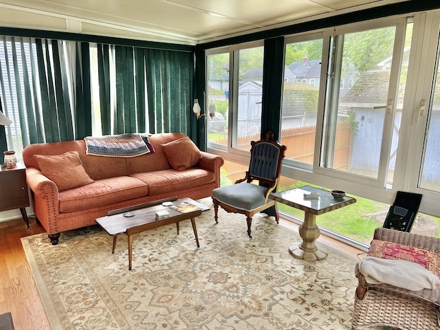 sunroom with wood finished floors and plenty of natural light