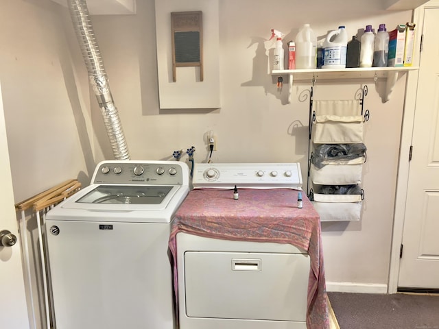 laundry room featuring washing machine and clothes dryer and baseboards