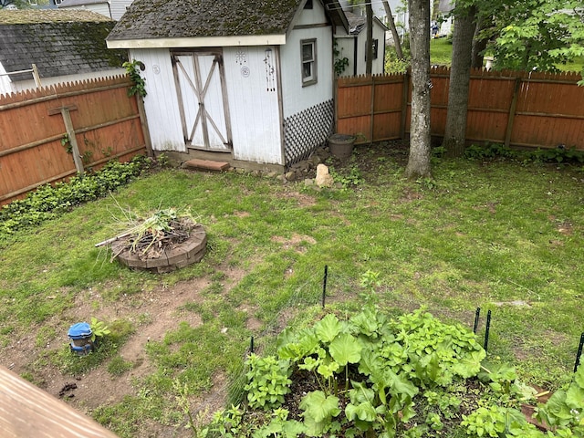 fenced backyard featuring a fire pit