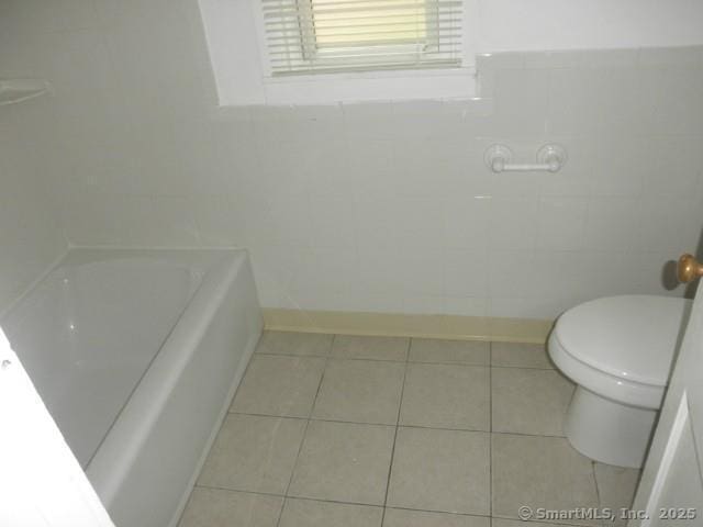 40 Wake St, Bridgeport, CT 06610 - full bathroom with tile walls, a tub, toilet, and tile patterned flooring