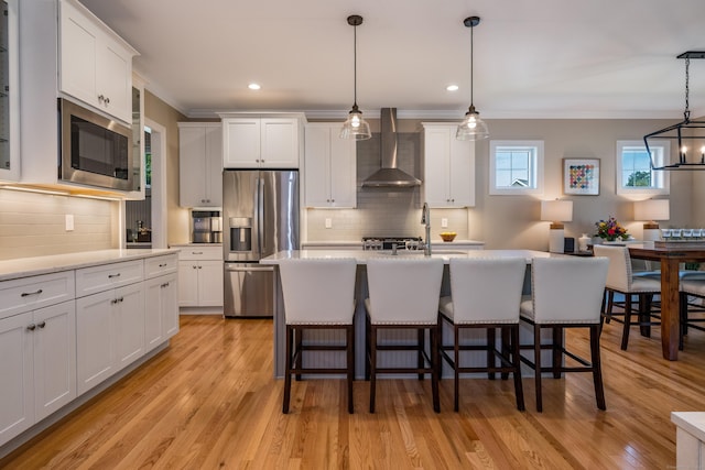 3 Prospect Rdg, Simsbury, CT 06070 - kitchen featuring appliances with stainless steel finishes, wall chimney range hood, crown molding, backsplash, and a breakfast bar area