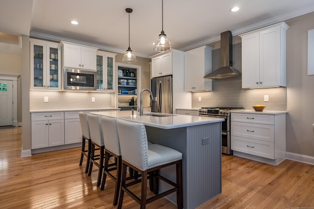 3 Prospect Rdg, Simsbury, CT 06070 - kitchen with wall chimney range hood, stainless steel appliances, a kitchen bar, decorative backsplash, and light countertops