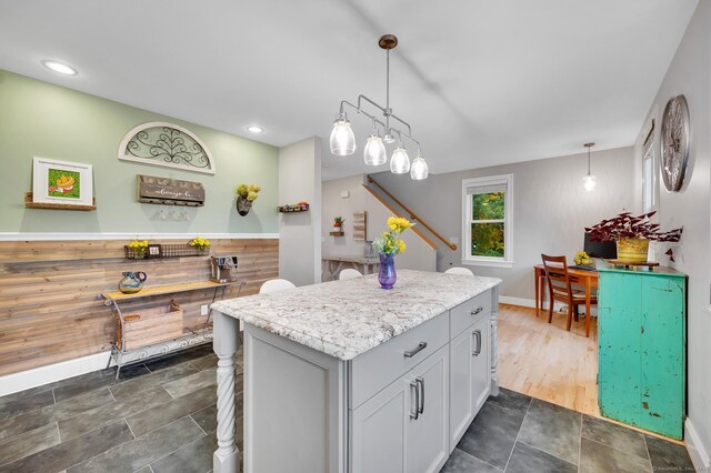 645 Prospect Ave Unit 11, West Hartford, CT 06105 - kitchen with a kitchen island, pendant lighting, baseboards, and dark stone finish floors