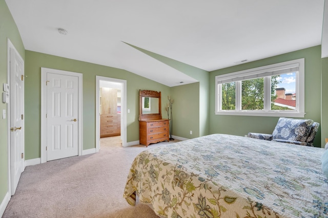 645 Prospect Ave Unit 11, West Hartford, CT 06105 - carpeted bedroom with baseboards, ensuite bath, and lofted ceiling