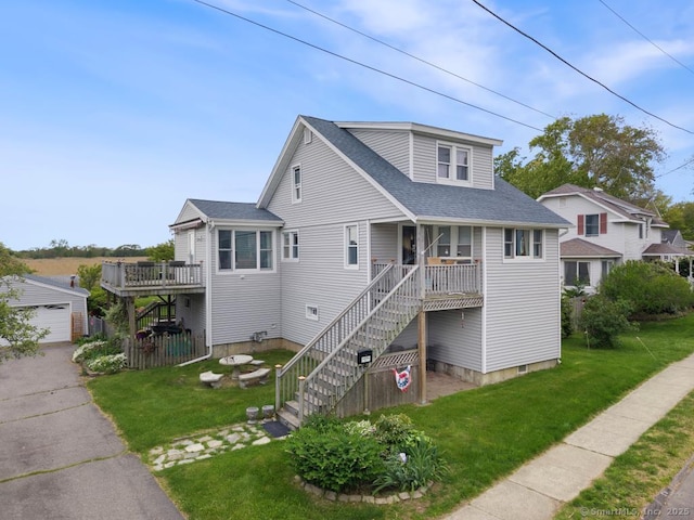 62 Surf Ave, Milford, CT 06460 - view of front of house with stairway, a front yard, roof with shingles, and a garage