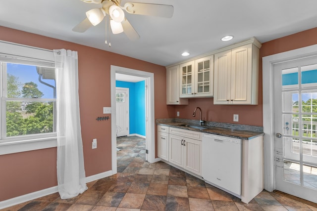 62 Surf Ave, Milford, CT 06460 - kitchen with dishwasher, a sink, baseboards, dark countertops, and glass insert cabinets