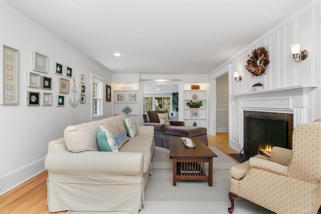 11 Overlook Rd, Westport, CT 06880 - living area with wood finished floors, a brick fireplace, built in shelves, and recessed lighting