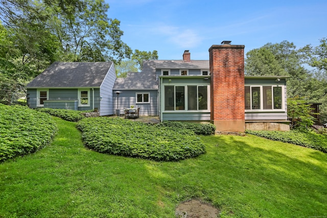 11 Overlook Rd, Westport, CT 06880 - back of house with a sunroom, a chimney, and a lawn