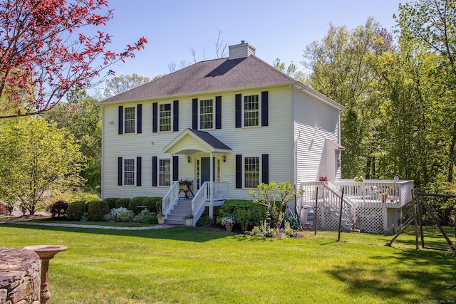 23 Anita Way, Warren, CT 06754 - colonial house featuring a chimney, a front lawn, a wooden deck, and a shingled roof