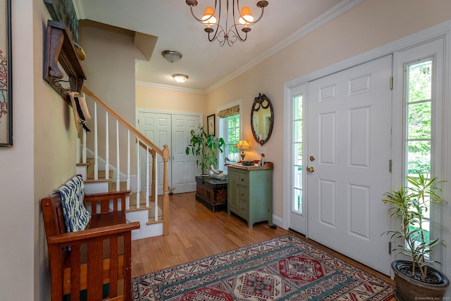 23 Anita Way, Warren, CT 06754 - foyer featuring a chandelier, light wood-style floors, stairway, and crown molding