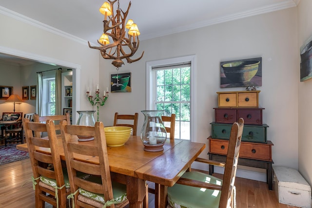 23 Anita Way, Warren, CT 06754 - dining space featuring light wood-style floors, a chandelier, and ornamental molding