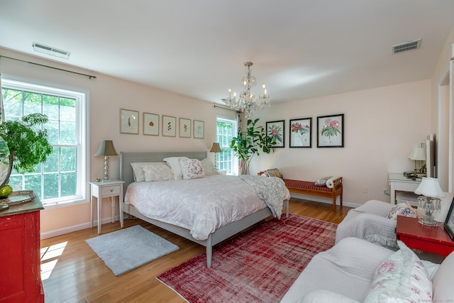 23 Anita Way, Warren, CT 06754 - bedroom featuring multiple windows, a chandelier, wood finished floors, and baseboards