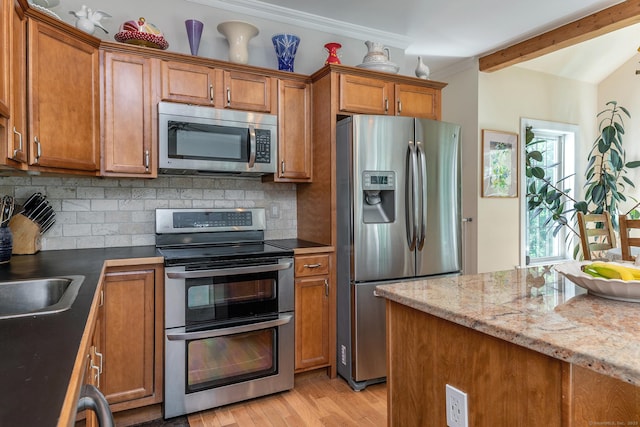 23 Anita Way, Warren, CT 06754 - kitchen featuring stainless steel appliances, brown cabinets, backsplash, and ornamental molding