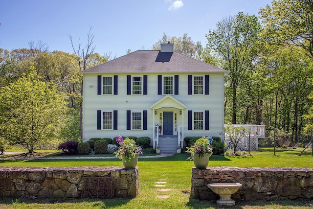 23 Anita Way, Warren, CT 06754 - colonial house with a chimney, a front lawn, and a deck
