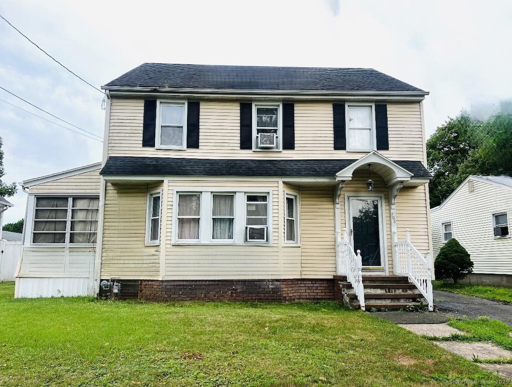 708 W Main St, West Haven, CT 06516 - view of front of home with entry steps, a front yard, and roof with shingles