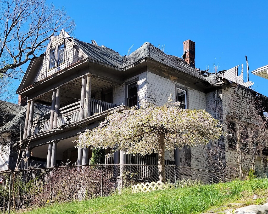 399 Willow St, Waterbury, CT 06710 - view of side of property featuring a balcony and a chimney