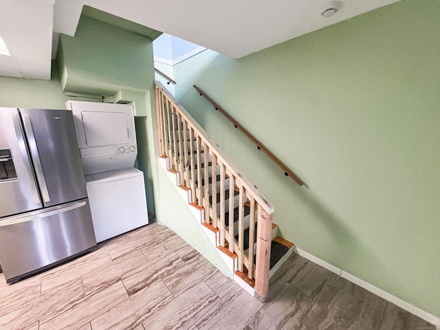 330 Short Beach Rd Apt F6, East Haven, CT 06512 - stairs with stacked washer / dryer and baseboards