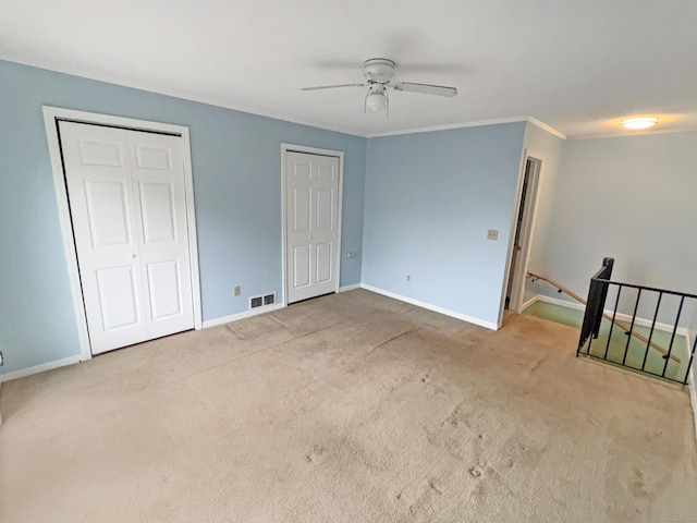 330 Short Beach Rd Apt F6, East Haven, CT 06512 - unfurnished bedroom with two closets, baseboards, carpet, ceiling fan, and crown molding