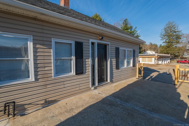 670 Putnam Pike, Rhode Island, RI 02828 - view of side of home featuring a chimney and a patio area